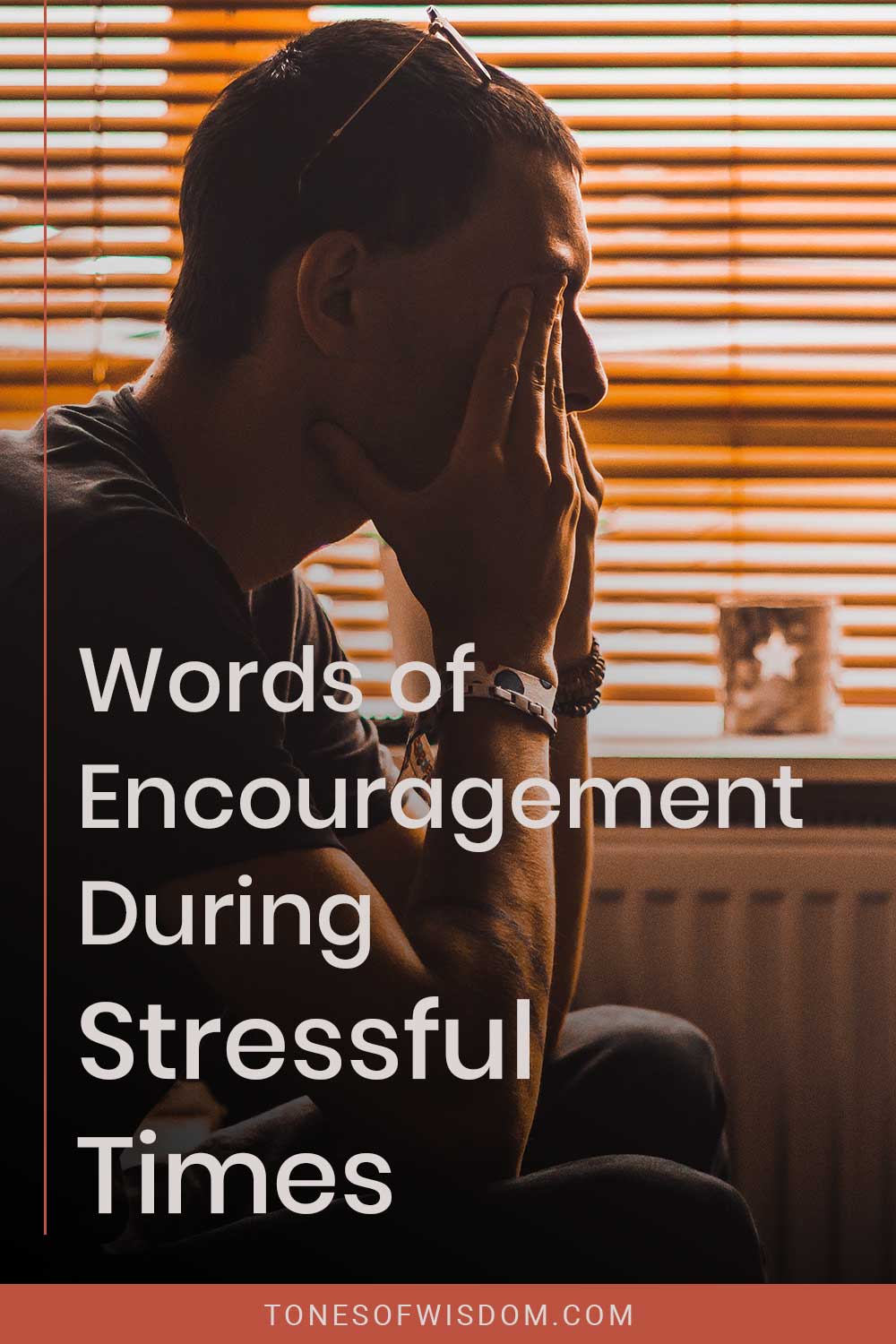 A stressed man sitting beside the window in a room - Words of Encouragement During Stressful Times