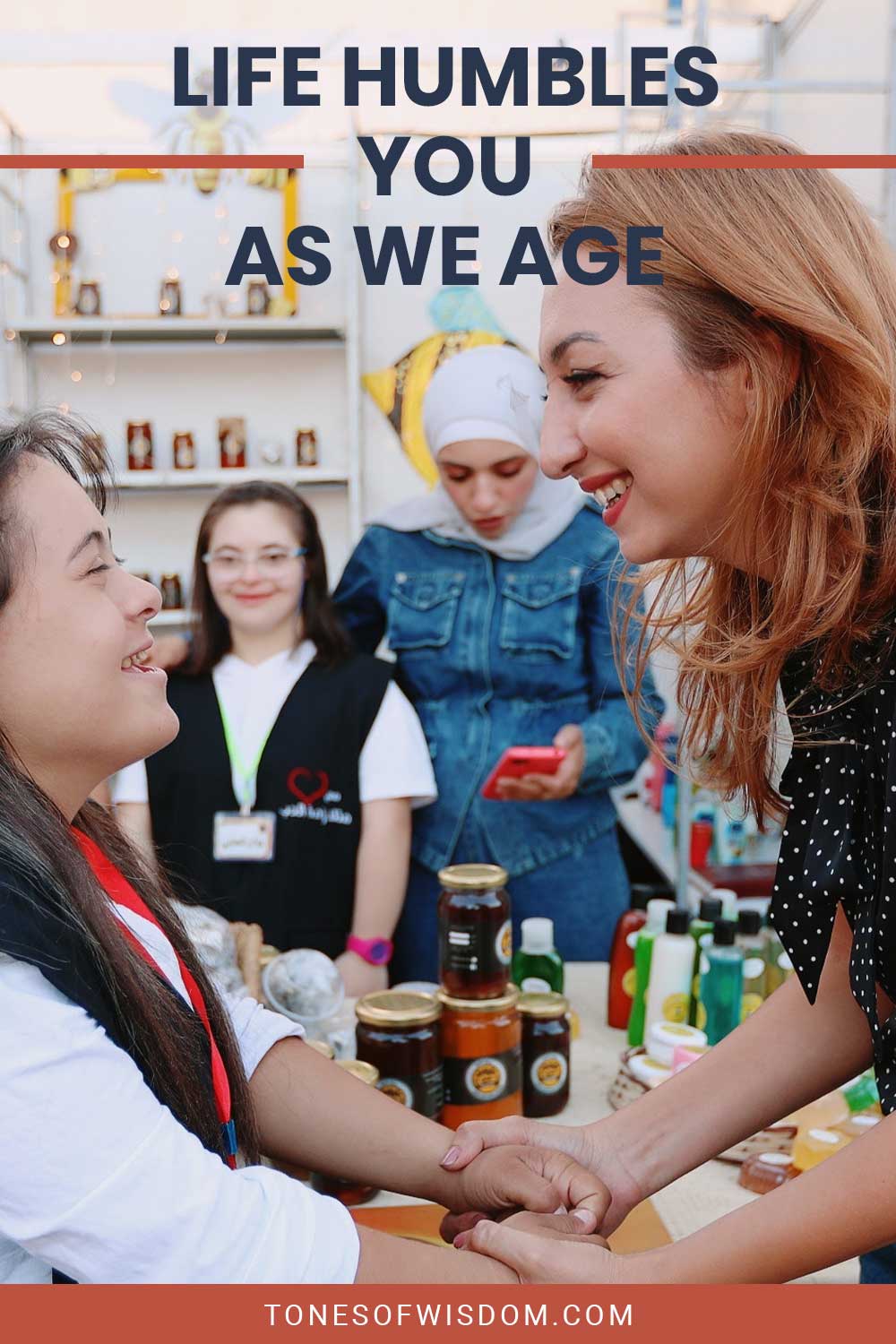 Woman smiling at a girl holding her hands - Life Humbles You As We Age