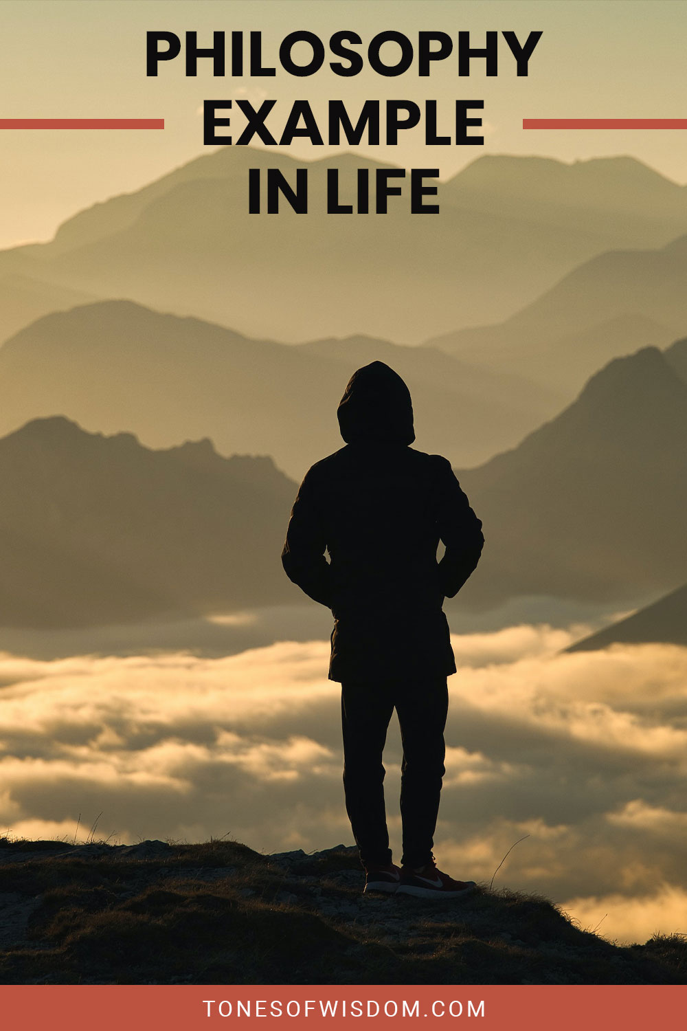 Person in a long hoodie standing on the top of a mountain - Philosophy Example In Life