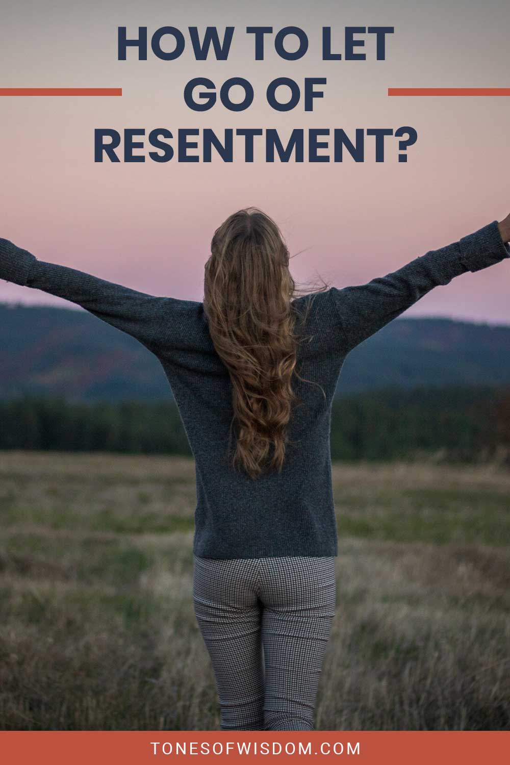 A woman spreading her hands in the air standing on a big empty field - How To Let Go Of Resentment?