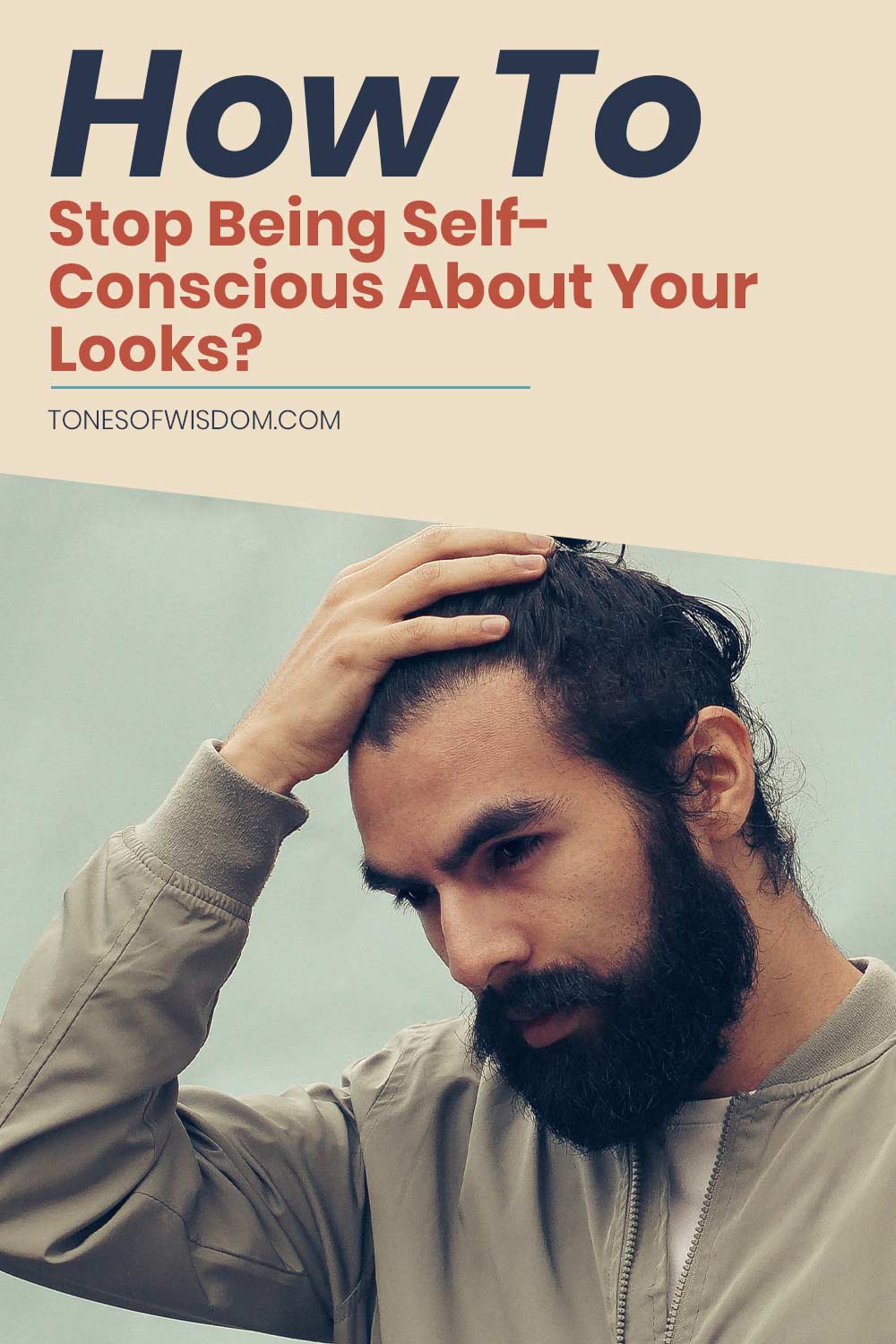 Bearded man holding his hand on head - How To Stop Being Self-Conscious About Your Looks?